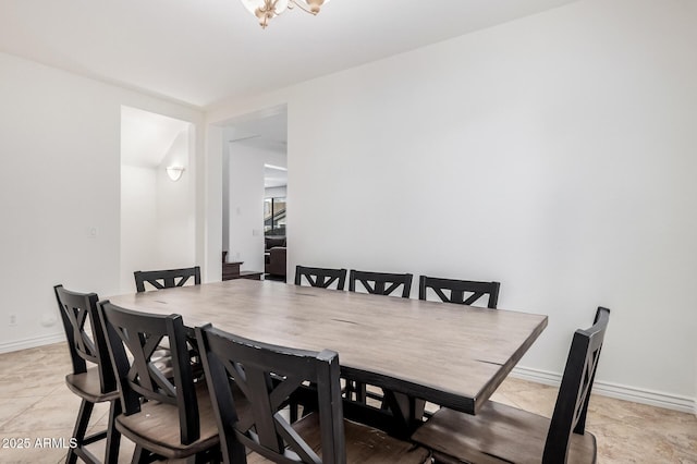 dining space featuring baseboards