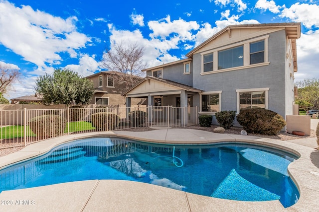 view of swimming pool with a patio area, fence, and a fenced in pool