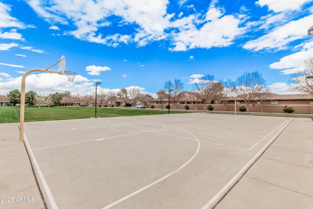 view of basketball court with community basketball court and a yard