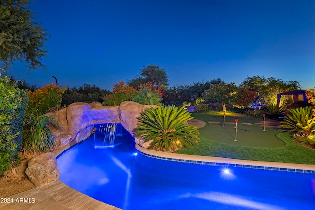 view of pool at twilight