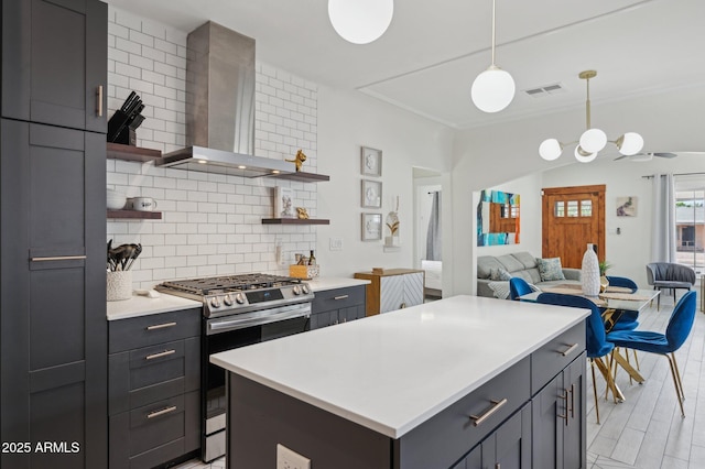 2310 N 11th St, Phoenix, AZ 85006 - kitchen featuring stainless steel range with gas cooktop, open shelves, wall chimney exhaust hood, tasteful backsplash, and open floor plan