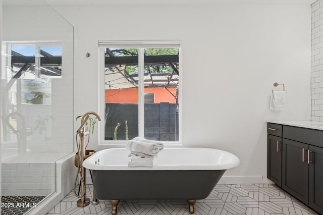 2310 N 11th St, Phoenix, AZ 85006 - bathroom featuring vanity, a soaking tub, tiled shower, and baseboards