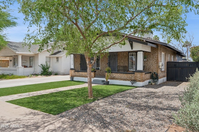 2310 N 11th St, Phoenix, AZ 85006 - view of front of house with brick siding, covered porch, and driveway