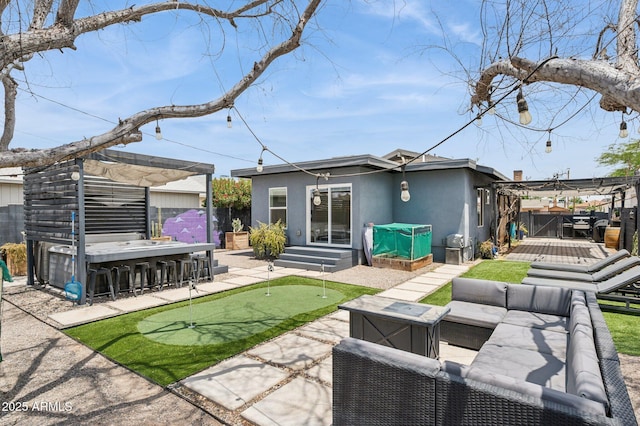 2310 N 11th St, Phoenix, AZ 85006 - rear view of house with a putting green, a wooden deck, stucco siding, outdoor lounge area, and a fenced backyard