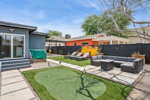 2310 N 11th St, Phoenix, AZ 85006 - fenced backyard with an area to practice putting, outdoor lounge area, a patio, and entry steps
