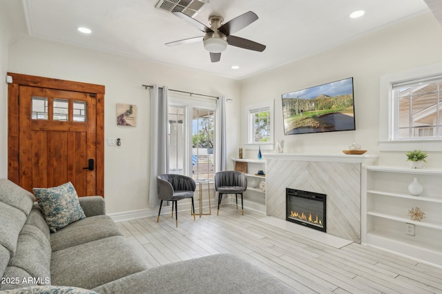 2310 N 11th St, Phoenix, AZ 85006 - living area featuring wood finished floors, a fireplace, a ceiling fan, baseboards, and recessed lighting