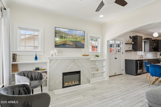 2310 N 11th St, Phoenix, AZ 85006 - living room featuring healthy amount of natural light, a ceiling fan, light wood-type flooring, a tiled fireplace, and recessed lighting