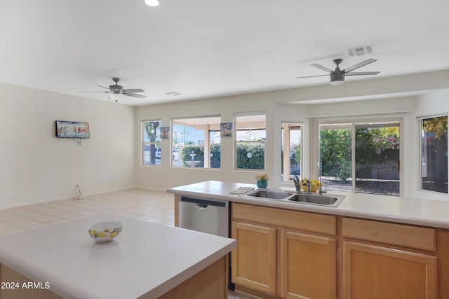 kitchen featuring dishwasher, a center island, sink, and ceiling fan