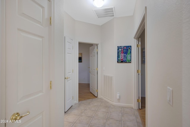 hall featuring light tile patterned floors