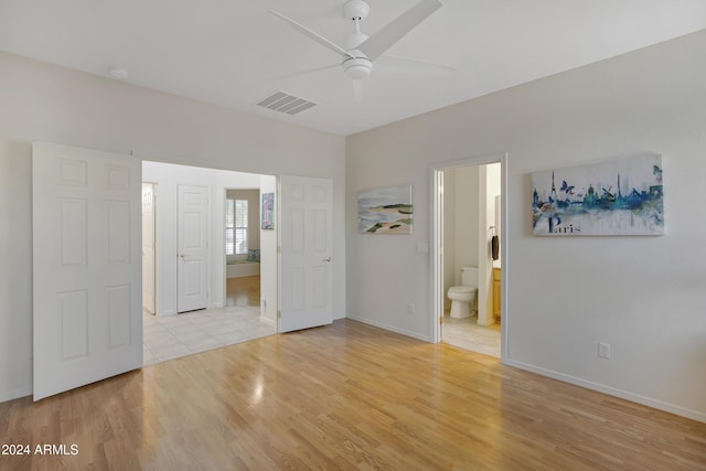 empty room with ceiling fan and light hardwood / wood-style flooring