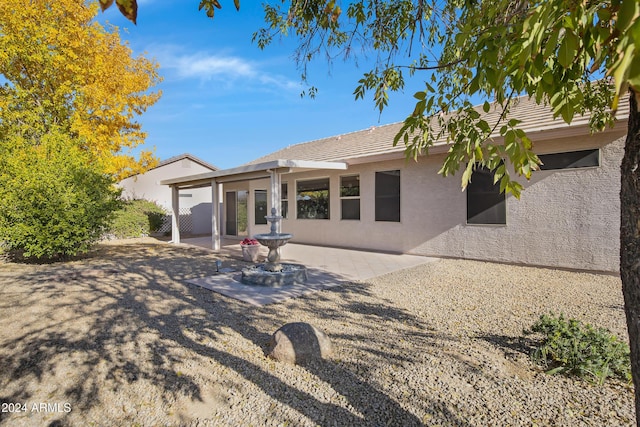 rear view of house featuring a patio