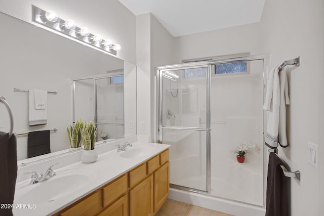 bathroom featuring tile patterned floors, vanity, and walk in shower