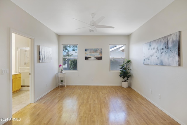 spare room with ceiling fan and light hardwood / wood-style flooring