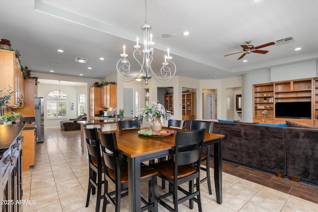 dining space with light tile patterned floors, a chandelier, a ceiling fan, and recessed lighting