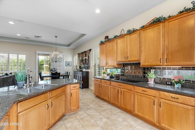 kitchen featuring a sink, black electric stovetop, light tile patterned flooring, recessed lighting, and a chandelier