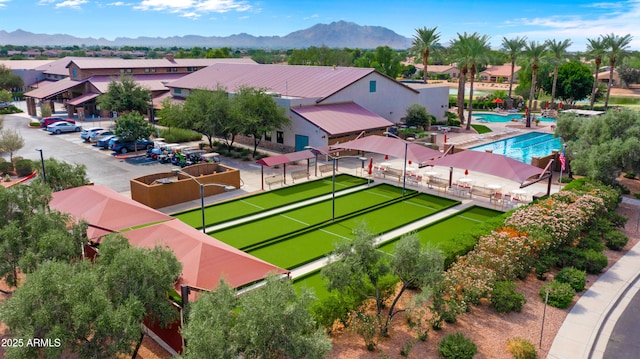 aerial perspective of suburban area featuring a pool and a mountain backdrop