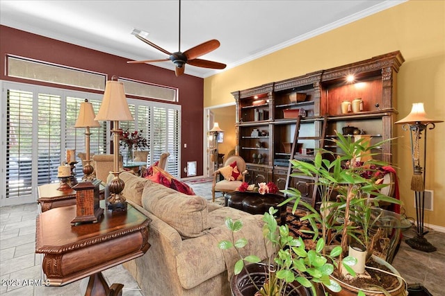 living area featuring a ceiling fan and crown molding