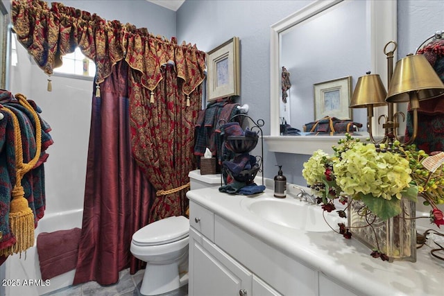 full bath featuring toilet, vanity, and tile patterned flooring