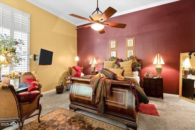 bedroom featuring carpet floors, baseboards, crown molding, and a ceiling fan