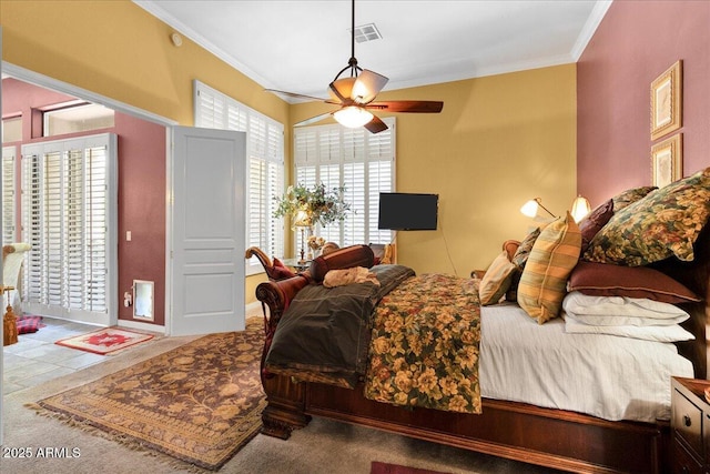 bedroom with carpet floors, ornamental molding, and ceiling fan