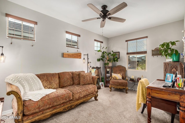 carpeted living area featuring ceiling fan