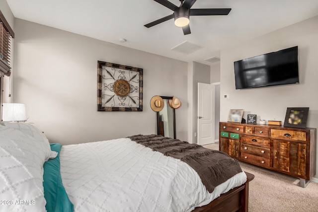bedroom featuring visible vents, a ceiling fan, and light colored carpet