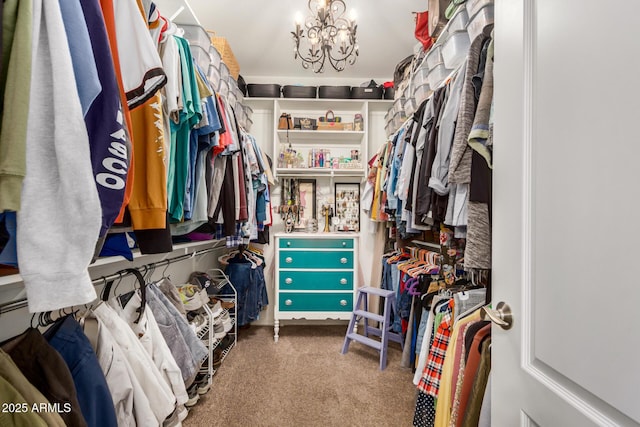 walk in closet with carpet flooring and a chandelier
