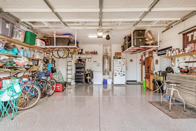 garage featuring freestanding refrigerator, a workshop area, a garage door opener, and water heater