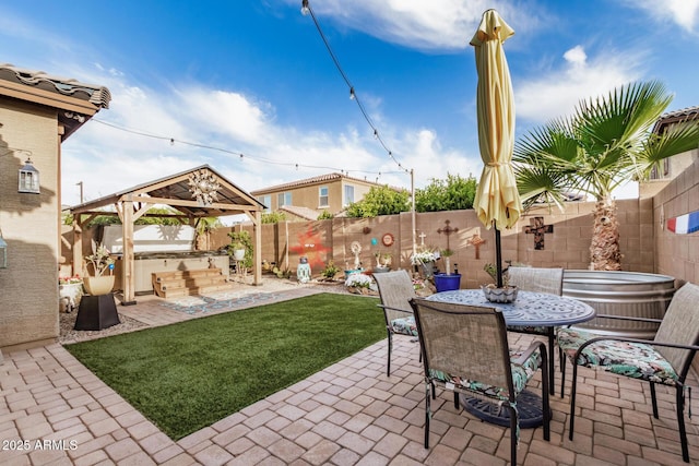 view of patio / terrace with a fenced backyard, outdoor dining space, a gazebo, and exterior kitchen
