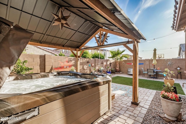 view of patio featuring a gazebo, a fenced backyard, a hot tub, and outdoor dining area
