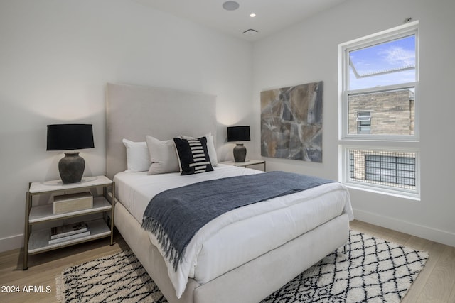 bedroom with light hardwood / wood-style floors