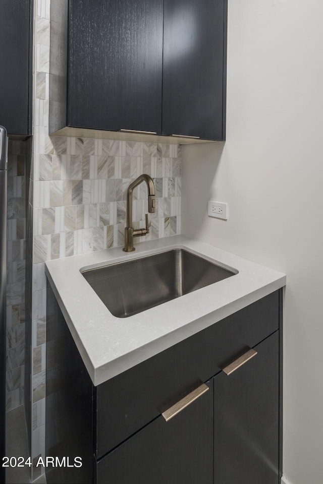 interior space featuring sink and backsplash