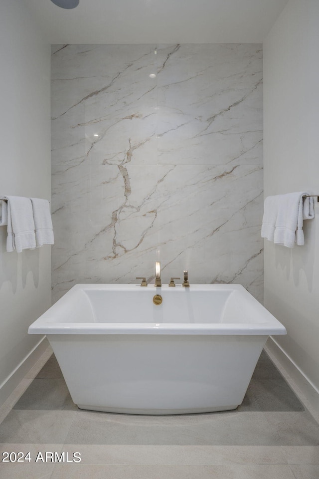 bathroom with tile floors, a bath to relax in, and tile walls