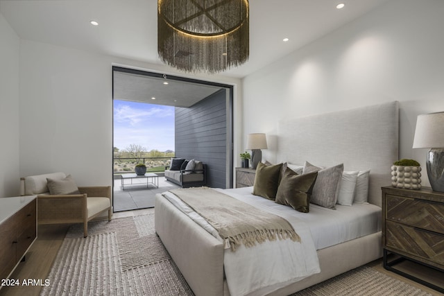 bedroom with access to exterior and wood-type flooring