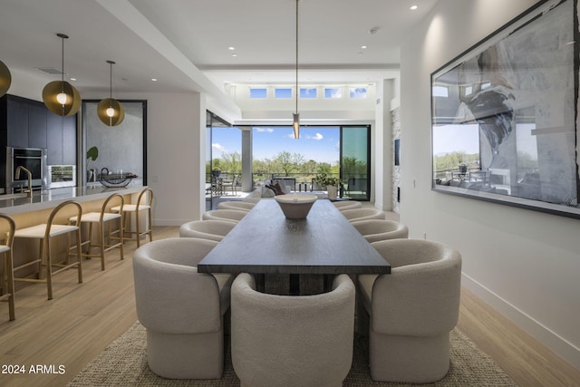 dining room with sink and light hardwood / wood-style flooring