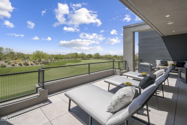 view of patio with an outdoor living space and a balcony