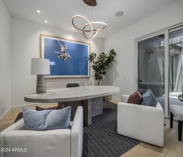 dining area featuring an inviting chandelier and hardwood / wood-style flooring