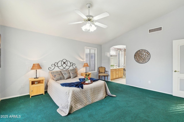 carpeted bedroom featuring vaulted ceiling, ceiling fan, and ensuite bathroom