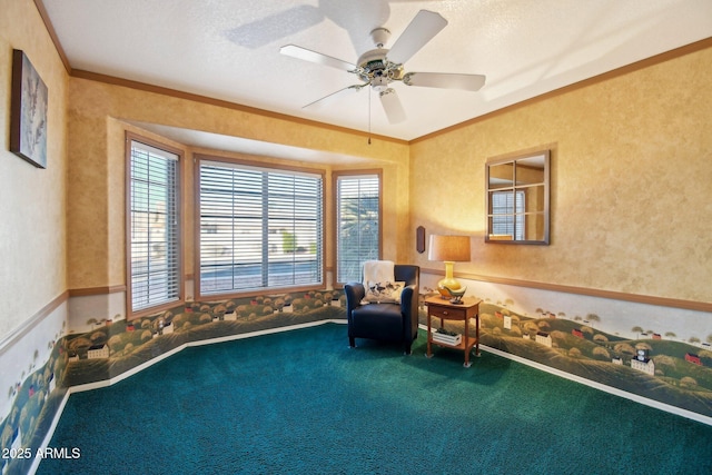 living area with ceiling fan, carpet, ornamental molding, and a textured ceiling