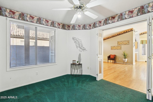 carpeted empty room featuring ceiling fan