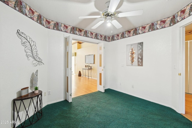 spare room featuring ceiling fan and carpet flooring