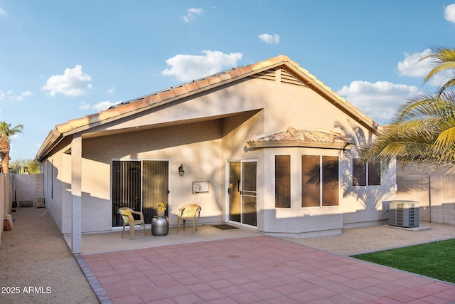 back of house featuring cooling unit and a patio area