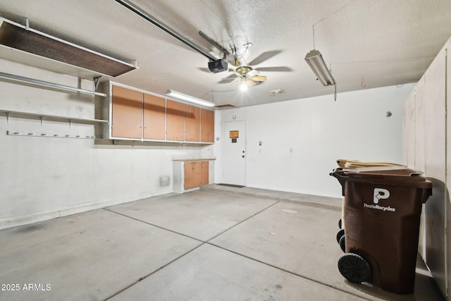 garage featuring a garage door opener and ceiling fan