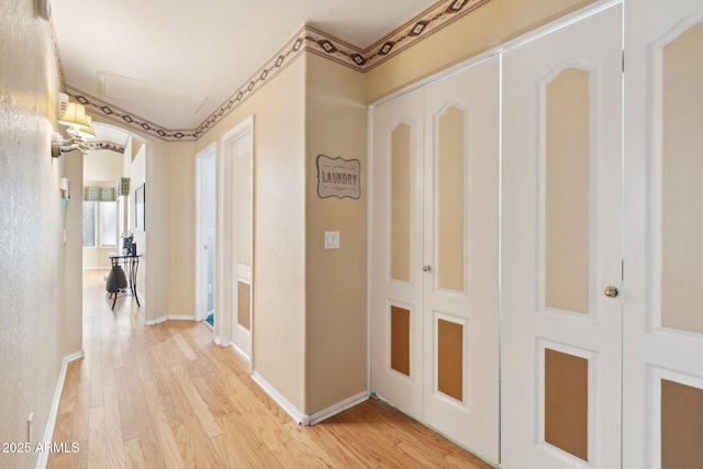 hallway with light hardwood / wood-style flooring