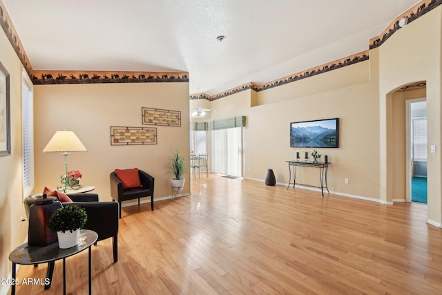 living area featuring ceiling fan and light wood-type flooring