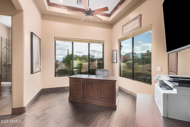 home office featuring a ceiling fan, crown molding, dark wood-style floors, and baseboards