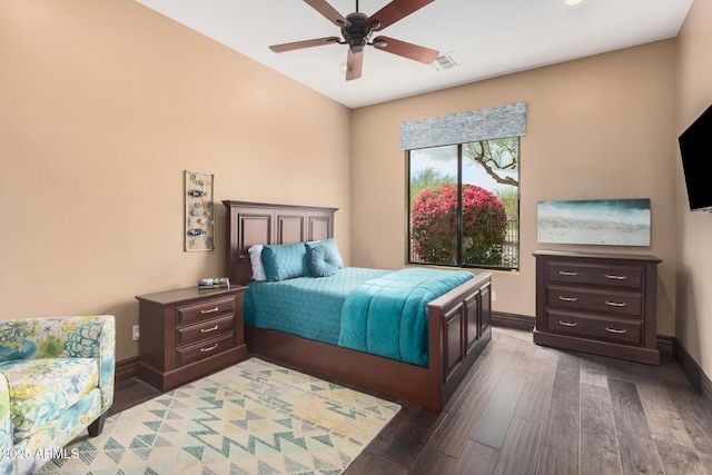 bedroom with visible vents, baseboards, wood finished floors, and a ceiling fan