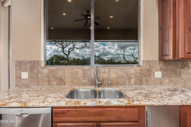 kitchen featuring a sink, backsplash, brown cabinetry, light stone countertops, and dishwasher