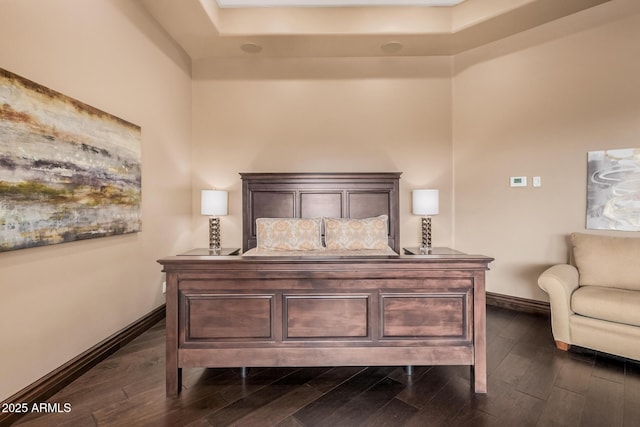 bedroom featuring baseboards and dark wood-style flooring