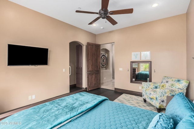 bedroom with recessed lighting, baseboards, arched walkways, and wood finished floors